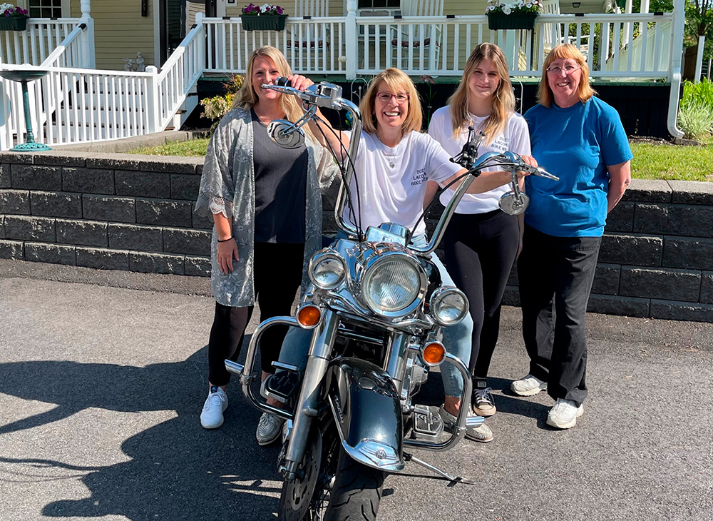 Bernadette and her staff enjoying Motorcycle week in front of the Inn